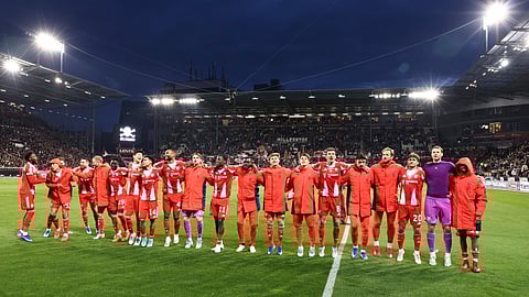 Bayern players celebrate after the German first division Bundesliga football match between FC St Pauli and FC Bayern Munich in Hamburg, northern Germany, on April 11, 2026.