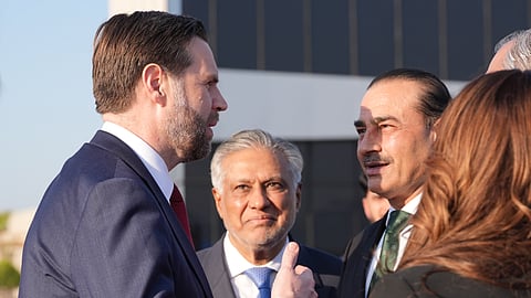 US Vice President JD Vance, left, talks to Pakistan's Chief of Defence Forces and Chief of Army Staff Field Marshall Asim Munir, right, and Pakistani Deputy Prime Minister and Foreign Minister Mohammad Ishaq Dar, center, before boarding Air Force Two after attending talks on Iran in Islamabad, Pakistan, Sunday, April 12, 2026.