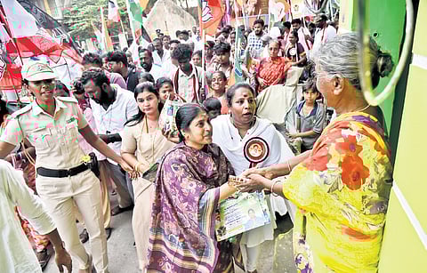 Porkodi undertaking door-to-door campaigning, her toddler (below) in arms, in Thiru Vi Ka Nagar.