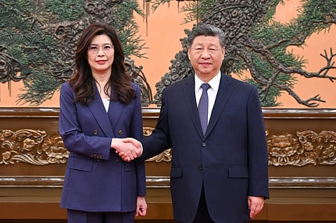 Chinese President Xi Jinping, right shakes hands with Kuomintang (KMT) party leader Cheng Li-wun in Beijing on Friday, April 10, 2026.