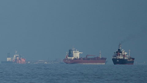 FILE - Oil tankers and cargo ships line up in the Strait of Hormuz as seen from Khor Fakkan, United Arab Emirates, Wednesday, March 11, 2026.