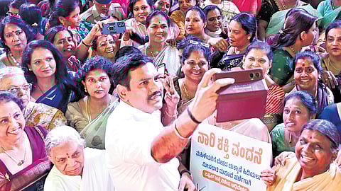 State BJP chief BY Vijayendra takes a selfie at the Town Hall for Women on the Nari Shakthi Vandana Act-2026 in Bengaluru on Monday. Union MoS and Bengaluru North MP Shobha Karandlaje is seen.