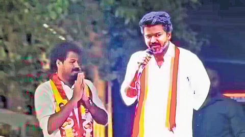 A life-sized digital projection of TVK chief appeared alongside the party’s Kumbakonam candidate K Vinoth, on Sunday