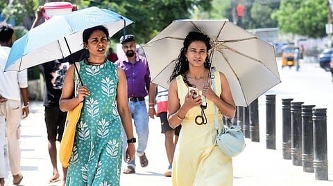 Women shield themselves with umbrellas from the scorching sun on Ethiraj Salai in Egmore on Sunday.