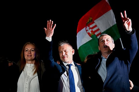 Peter Magyar, leader of the opposition Tisza party, center, celebrates with his party colleagues following the announcement of the partial results of the parliamentary election, in Budapest, Hungary, Sunday, April 12, 2026.
