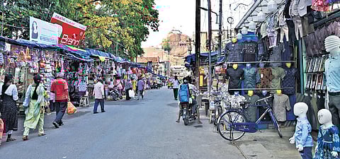 Amidst the clutter, K Arockiaraj, a loadman, pauses mid-task to reflect on both livelihood and politics.