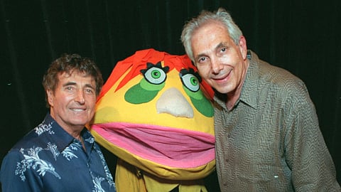 Puppeteers Sid Krofft, left, and Marty Krofft stand next to H.R. Pufnstuf, one of their many creations, at an auction in Beverly Hills, Calif., on Aug. 23, 1998.