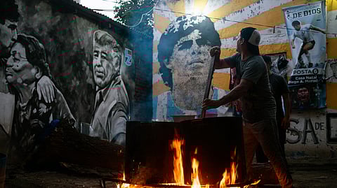 Alejandro, a volunteer, prepares a stew for neighbours in need at the yard of the childhood home of the late football star Diego Maradona, now transformed into a soup kitchen, in Villa Fiorito, Buenos Aires province, Argentina, on April 9, 2026.