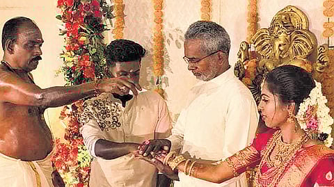 Fr Roy Vadakkel, director of Bethlehem Ashramam, placing Parvathi’s hand in Ananthu’s, as the bride’s father