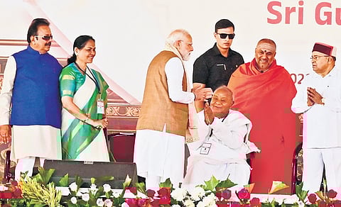 Prime Minister Narendra Modi greets JDS supremo H D Deve Gowda at Adichunchanagiri mutt in Mandya district on Wednesday. Governor Thaawarchand Gehlot, Adichunchanagiri Mutt seer Nirmalanandanatha Swamiji, Union Minister of State Shobha Karandlaje and others look on.