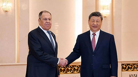 This handout picture posted on the Telegram account of the Russian Foreign Ministry on April 15, 2026 shows Russia's Foreign Minister Sergei Lavrov (L) shaking hands with China's President Xi Jinping in Beijing.