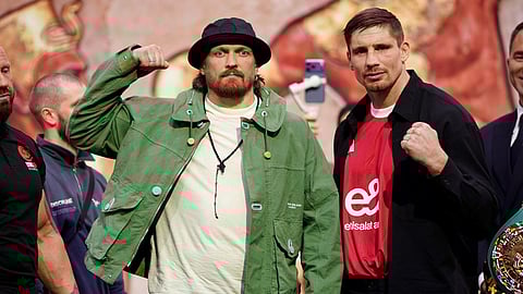 Boxers Oleksandr Usyk, left, the WBC heavyweight champion, and challenger Rico Verhoeven pose during a press conference in London, Tuesday, April 14, 2026.