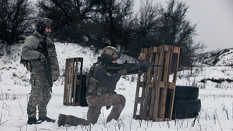 Soldiers from Ukraine's Khartia brigade practice shooting at a training ground in the Kharkiv region, Ukraine, Feb. 14, 2026.