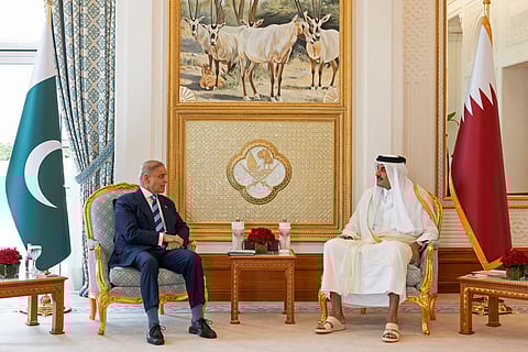 This handout photograph taken and released by Qatar's Amiri Diwan on April 16, 2026 shows Qatar's Emir Sheikh Tamim bin Hamad Al-Thani (R) speaking with Pakistan's Prime Minister Shehbaz Sharif during their meeting in Doha.