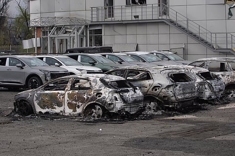 Burned-out cars are seen following a Russian strike in Kyiv on April 16, 2026, amid the Russian invasion of Ukraine.