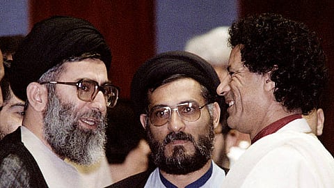The then Iranian president Hodjatoleslam Seyed Ali Khamenei (L) with Libyan leader Muammar Gaddafi (R) during the 8th Summit of the Non-Aligned Movement in 1986 in Harare, Zimbabwe