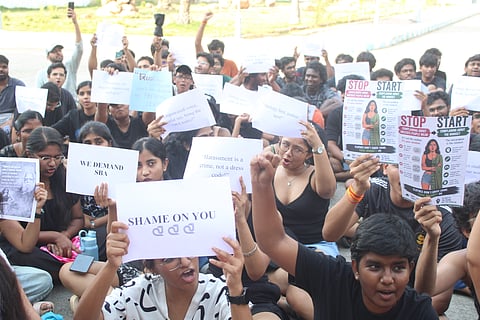 TNNLU students gather in protest near the administrative block in Tiruchy on Wednesday, many dressed in black, demanding accountability over alleged remarks by the Vice-Chancellor.