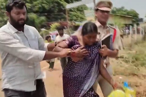 A woman being taken to hospital after allegedly attempting to consume pesticide during a grievance meeting in Munagala mandal headquarters, Suryapet district.