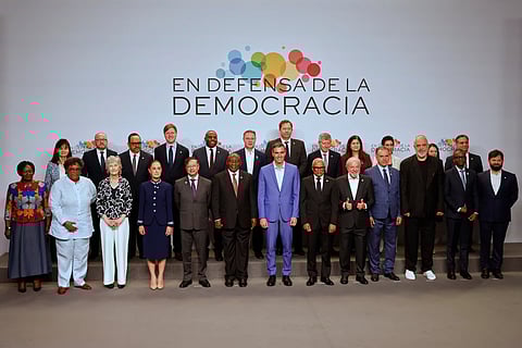 Spain's Prime Minister Pedro Sanchez, center, poses with attendees at the Meeting in Defence of Democracy summit in Barcelona, Spain, Saturday, April 18, 2026