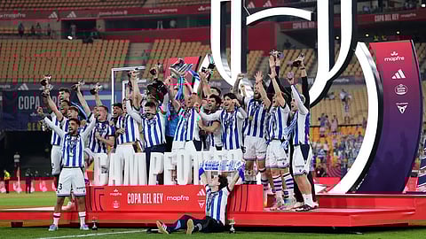 Real Sociedad's team players celebrate with the trophy after the Copa del Rey final soccer match between Atletico Madrid and Real Sociedad in Seville, Spain, Saturday, April. 18, 2026.