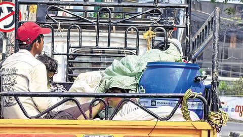 A youth shields himself from the scorching sun while travelling through Thampanoor in Thiruvananthapuram