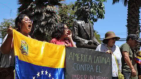 People protest against the US military operation in Venezuela with a sign reading "Latin America against imperialism" in Quito on January 3, 2026, after US forces captured Venezuelan leader Nicolas Maduro.