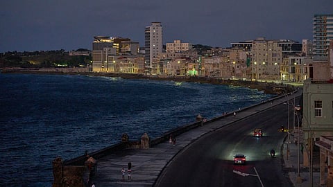 Vehicles traverse the Malecon at dusk in Havana, Wednesday, April 15, 2026.