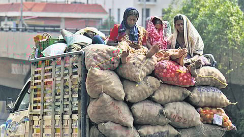 Vendors rest atop sacks of onions while travelling in a loaded goods vehicle on a hot afternoon near Begumpet; HYDRAA officials clear waterlogging following heavy rain at Gandimaisamma in Hyderabad on Sunday evening