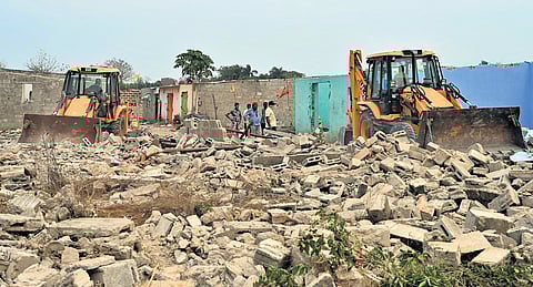 Bulldozers razing unauthorised structures at Shampur on Saturday.