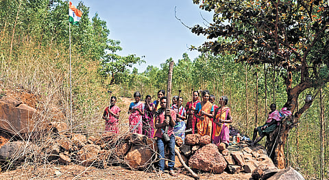 Armed with traditional weapons, tribal women block the road connecting SH-44 to Sijimali hill in Rayagada.