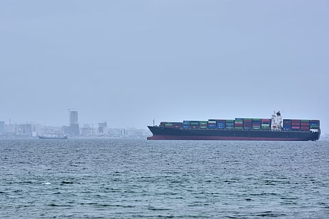 A container ship is seen in the Strait of Hormuz off the coast of Qeshm Island, Iran, Saturday, April 18, 2026.
