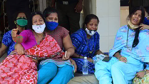 File | Family members of the deceased patients outside the Chamarajanagar