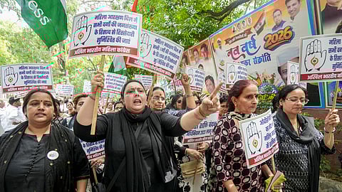 Congress workers hold placards during a protest march towards the BJP headquarters against the Constitution (131st Amendment) Bill on womens reservation, in New Delhi, Sunday, April 19, 2026.