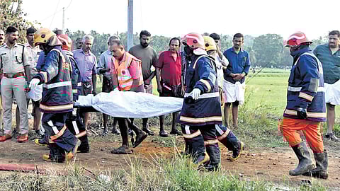 Rescue workers carrying away a body from the blast site | Express