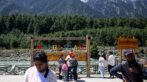 Tourists visit the selfie point along the banks of Lidder river in Pahalgam in south Kashmir’s Anantnag district on April 21, 2026.