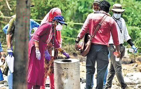 A forensic team collecting samples of the explosives from the blast site at Mundathicode in Thrissur on Wednesday.
