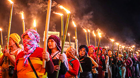 Protestors take part in a Meira (torch) rally at Koirengei, demanding justice regarding the Tronglaobi killing incident, in Imphal East on Sunday, April 20, 2026.