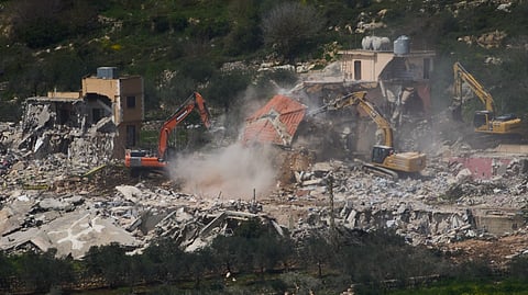 Israeli bulldozers demolish homes in southern Lebanon, as seen from northern Israel, Sunday, April 12, 2026.