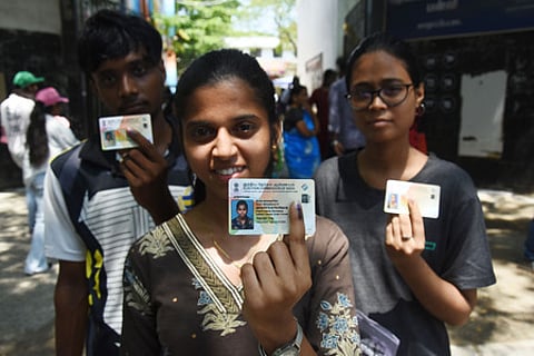 In this image from April 23, a 1st time voter casts her vote along with friends at saidapet govt high school for the Tamil Nadu Assembly elections.