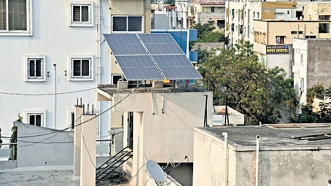Solar panels installed on the terrace of a residential building.