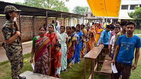 Security personnel stand guard during voting in the first phase of the West Bengal Assembly elections, at a polling station in Murshidabad, Thursday, April 23, 2026.