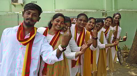 Young voters turn heads in white-and-khaki outfits inspired by Vijay as they arrive to cast their votes in Tiruchy (East).