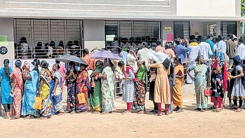Voters queue up outside a polling booth in Tirukkattuppalli, Thanjavur.