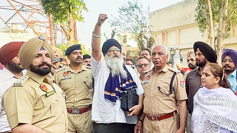 Gurjeet Singh Khalsa, centre, who had climbed a 400-foot tower, is brought down safely by the district administration, in Patiala district, Friday, April 24, 2026.