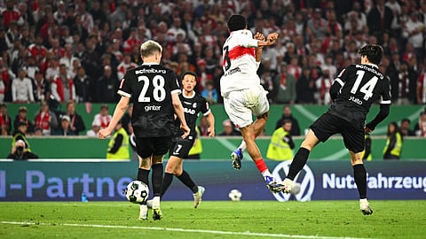 Stuttgart's Tiago Tomas, center, scores the winning goal during a German Cup semifinal soccer match between VfB Stuttgart and SC Freiburg, Thursday, April 23, 2026, in Stuttgart, Germany.