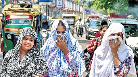 Women cover themselves on a hot summer day.