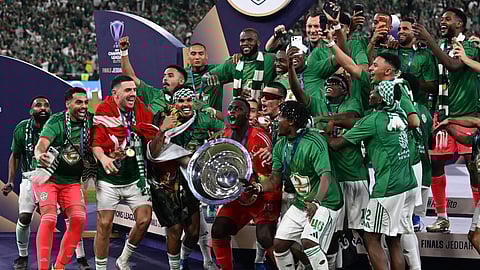 Al-Ahli players celebrate the trophy of AFC Champions League Elite after winning the match against Machida Zelvia, at King Abdullah Sports City Stadium, in Jeddah, Saudi Arabia, Saturday, April 25, 2026.