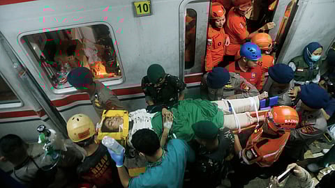 A passenger is being rescued after a train collision in Bekasi, Indonesia, Tuesday, April 28, 2026.