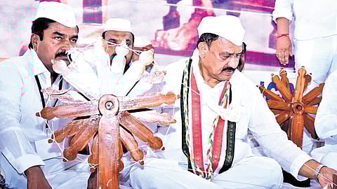 TPCC president B Mahesh Kumar Goud tries his hand at a charkha during a training session organised by the Telangana Pradesh Congress Seva Dal at Nampally Exhibition Ground in Hyderabad on Tuesday
