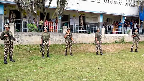 Security personnel stand guard during voting in the second and final phase of the West Bengal Assembly elections, in Khanakul, Hooghly district, Wednesday, April 29, 2026.